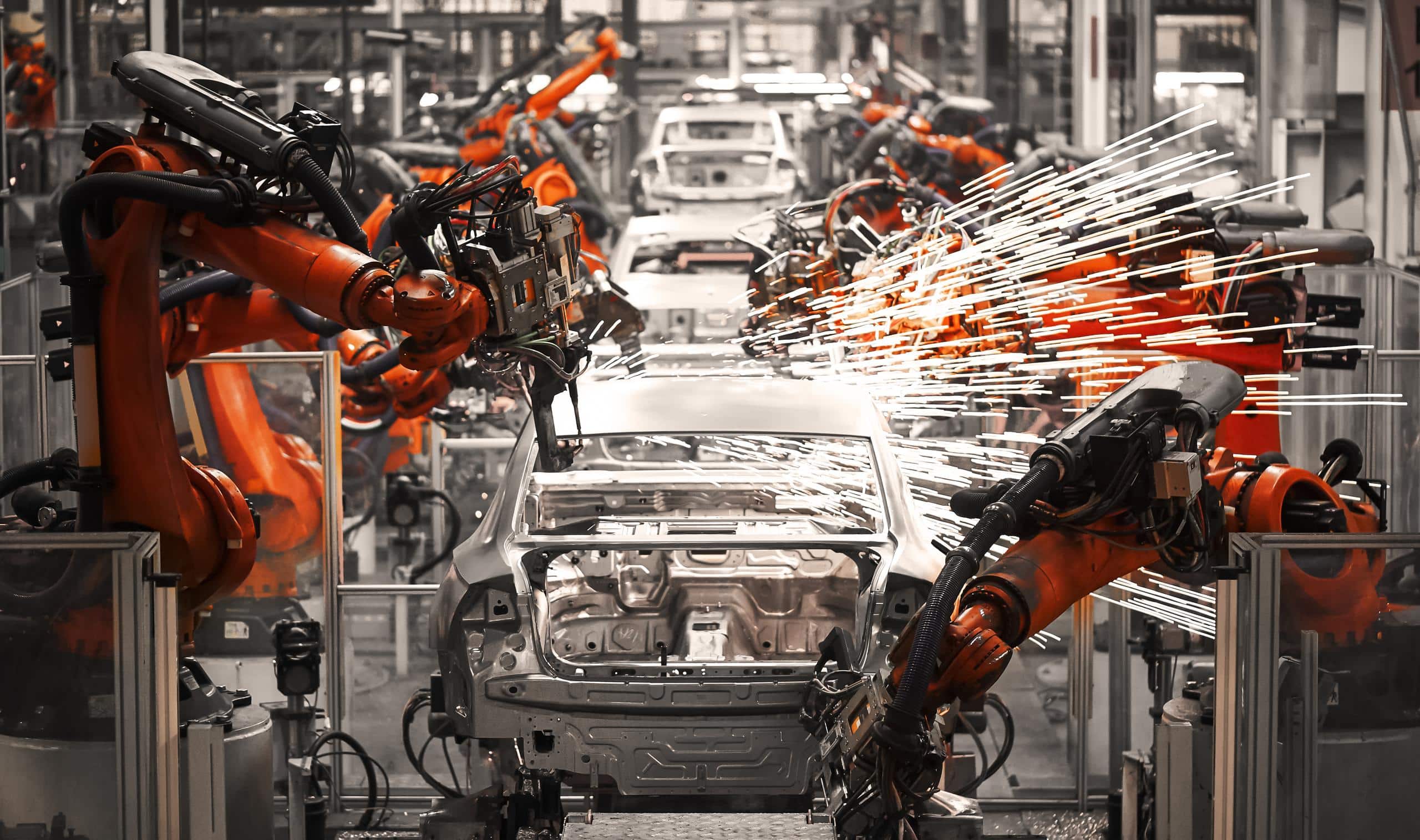 Photo of robots welding cars on a production line